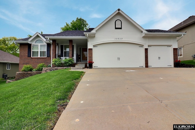 19523 Binney Cir, Elkhorn, NE 68022 - ranch-style home featuring brick siding, an attached garage, a front yard, concrete driveway, and a porch