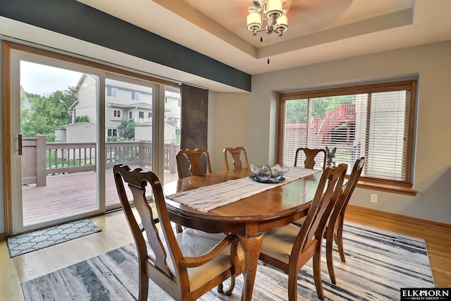 19523 Binney Cir, Elkhorn, NE 68022 - dining area with light wood-style flooring and a raised ceiling