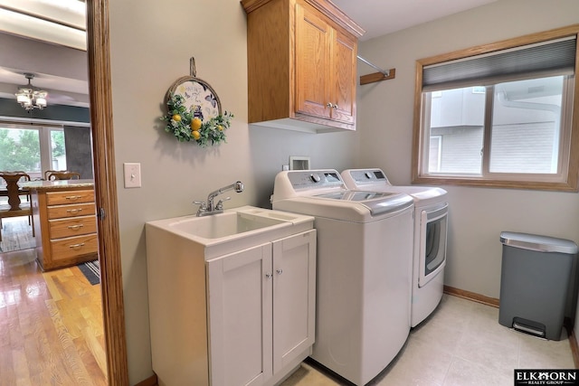 19523 Binney Cir, Elkhorn, NE 68022 - laundry area with cabinet space, washer and clothes dryer, and a chandelier