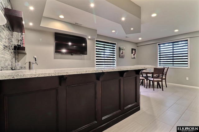 19523 Binney Cir, Elkhorn, NE 68022 - kitchen featuring healthy amount of natural light, recessed lighting, light stone countertops, and a peninsula