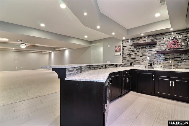 19523 Binney Cir, Elkhorn, NE 68022 - kitchen with open floor plan, a peninsula, backsplash, a breakfast bar, and light stone counters