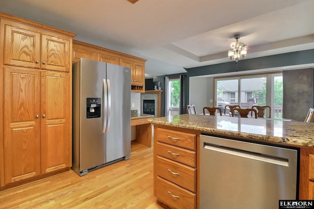 19523 Binney Cir, Elkhorn, NE 68022 - kitchen with stainless steel appliances, light wood finished floors, light stone counters, and brown cabinets