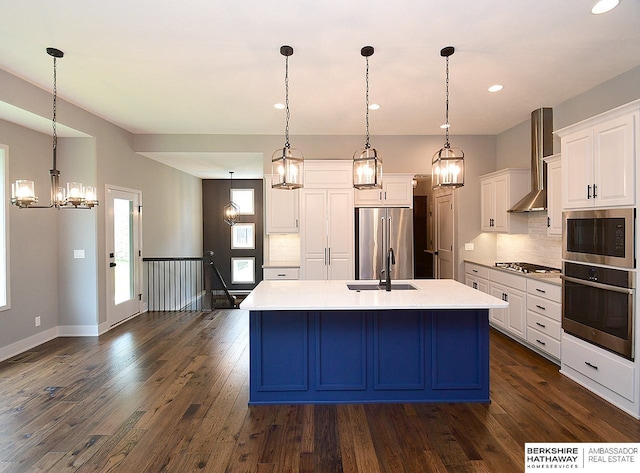 10309 S 102nd St, Papillion, NE 68046 - kitchen featuring stainless steel appliances, wall chimney exhaust hood, a chandelier, white cabinetry, and decorative backsplash