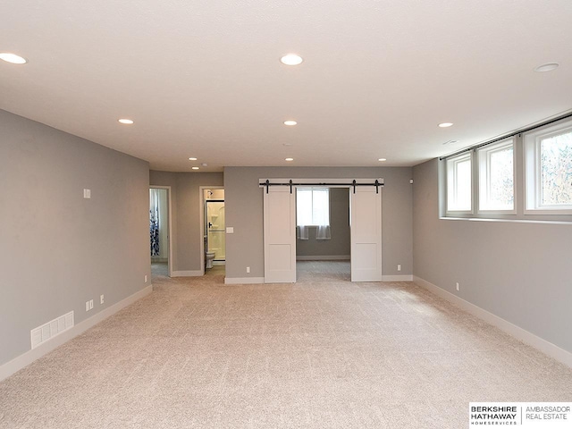 10309 S 102nd St, Papillion, NE 68046 - spare room featuring recessed lighting, a barn door, and light carpet