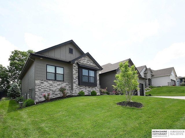 10309 S 102nd St, Papillion, NE 68046 - craftsman-style house with board and batten siding, stone siding, an attached garage, and a front lawn