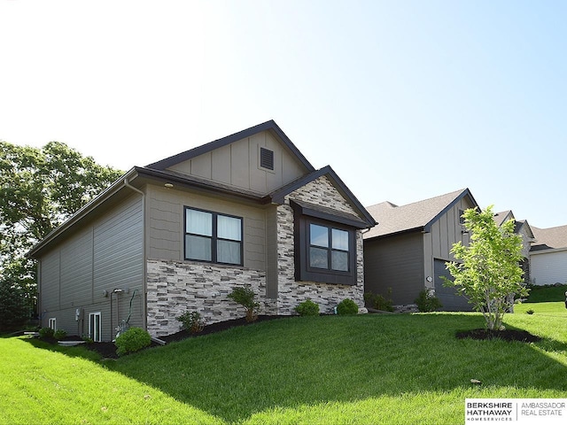 10309 S 102nd St, Papillion, NE 68046 - view of front facade featuring board and batten siding, stone siding, a front yard, and a garage