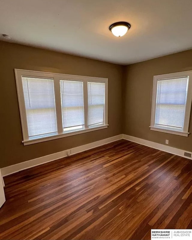 3427 N 45th St, Omaha, NE 68104 - empty room with dark wood-style floors and baseboards