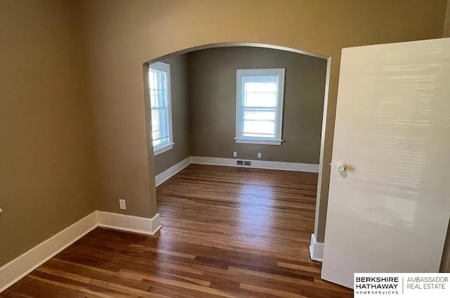 3427 N 45th St, Omaha, NE 68104 - spare room featuring arched walkways and wood finished floors