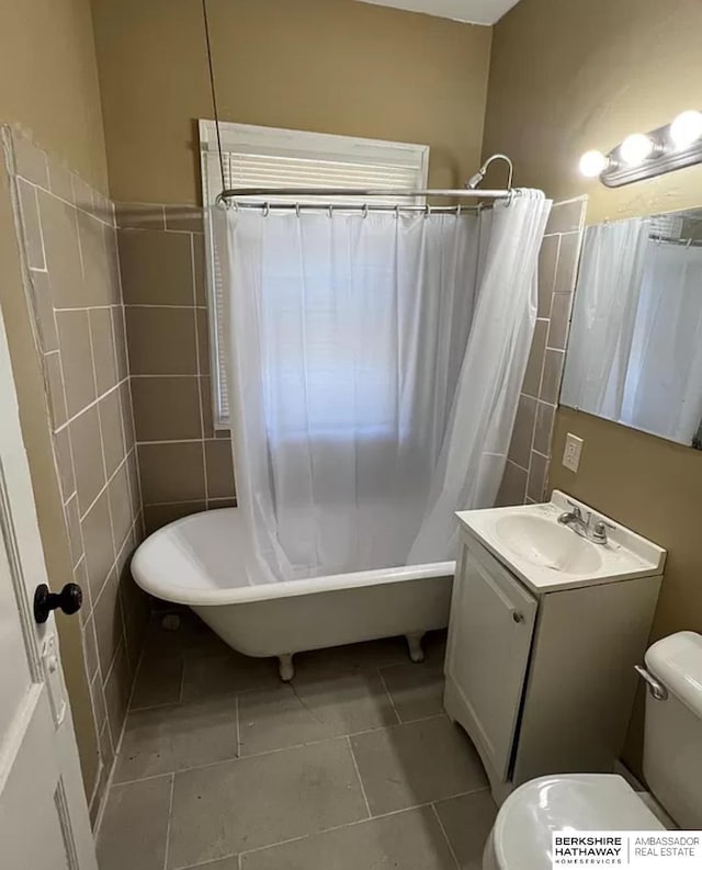 3427 N 45th St, Omaha, NE 68104 - bathroom featuring tile walls, vanity, tile patterned flooring, and shower / bath combo