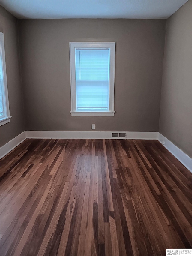 3427 N 45th St, Omaha, NE 68104 - spare room featuring healthy amount of natural light and dark wood-style flooring