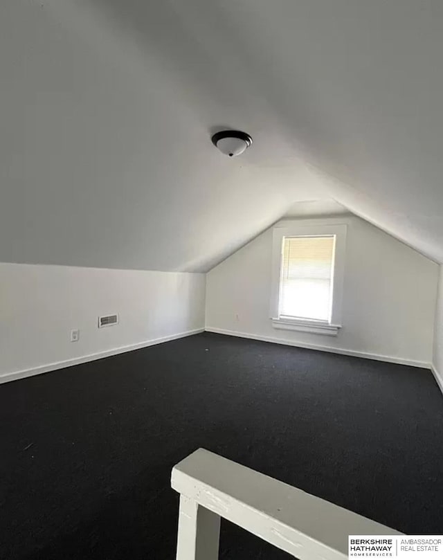3427 N 45th St, Omaha, NE 68104 - additional living space with lofted ceiling and dark carpet