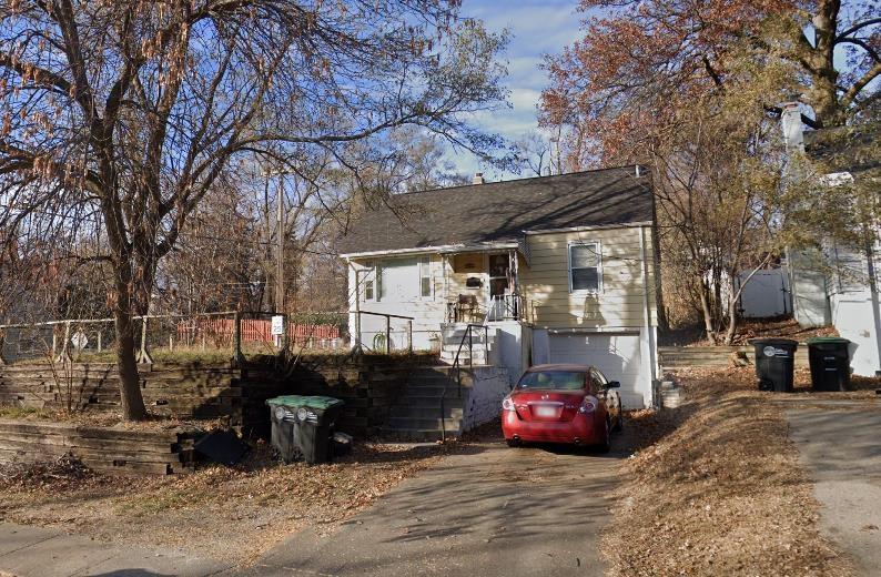 3902 N 52nd St, Omaha, NE 68104 - view of front facade with asphalt driveway and a garage