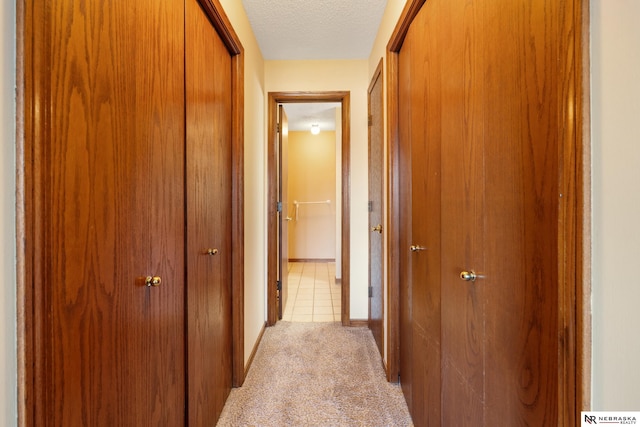 11937 Miracle Hills Dr Unit 11, Omaha, NE 68154 - hallway with a textured ceiling and light carpet
