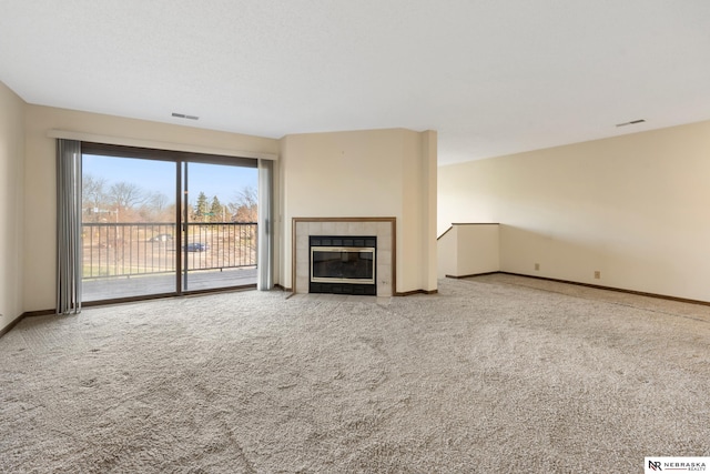 11937 Miracle Hills Dr Unit 11, Omaha, NE 68154 - unfurnished living room featuring carpet and a tile fireplace