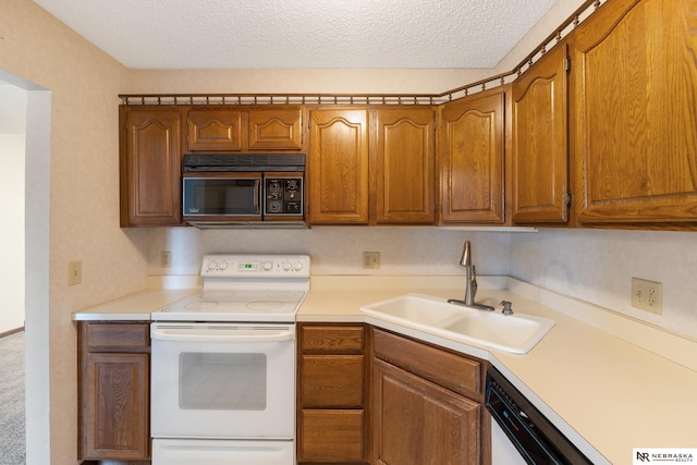 11937 Miracle Hills Dr Unit 11, Omaha, NE 68154 - kitchen with white electric stove, black microwave, brown cabinets, light countertops, and a textured ceiling