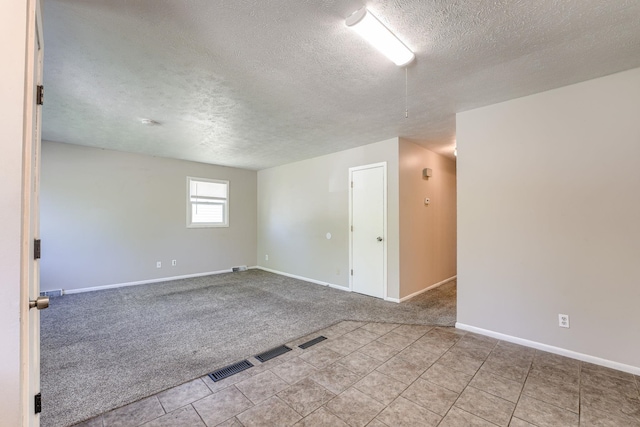 2811 S 36th St, Omaha, NE 68105 - spare room featuring a textured ceiling, carpet, and tile patterned floors
