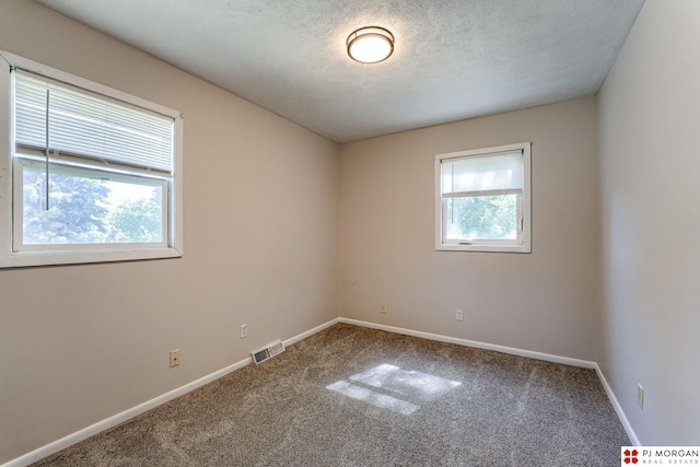 2811 S 36th St, Omaha, NE 68105 - carpeted spare room featuring baseboards and a textured ceiling