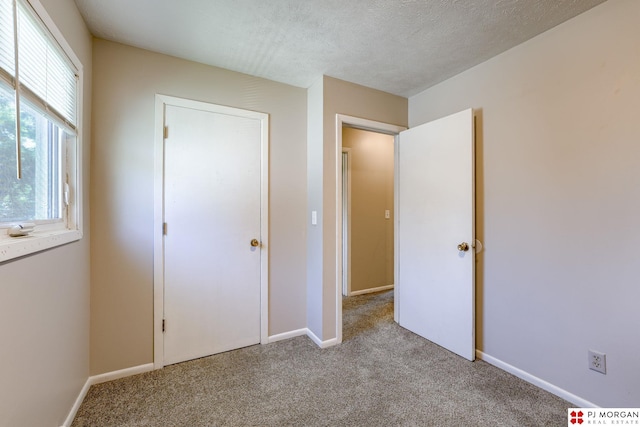 2811 S 36th St, Omaha, NE 68105 - unfurnished bedroom with light colored carpet and a textured ceiling