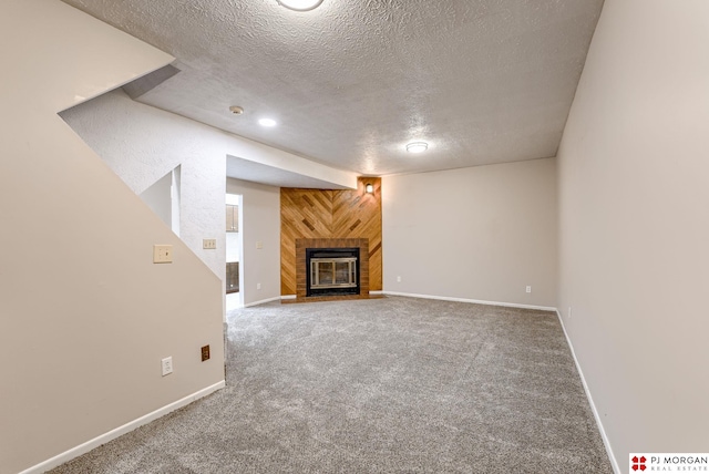 2811 S 36th St, Omaha, NE 68105 - unfurnished living room with a textured ceiling, a fireplace with flush hearth, and carpet