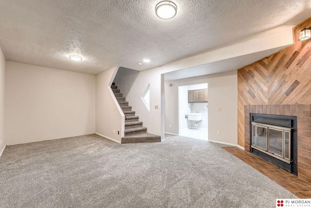 2811 S 36th St, Omaha, NE 68105 - unfurnished living room with a brick fireplace, stairway, a textured ceiling, wooden walls, and carpet