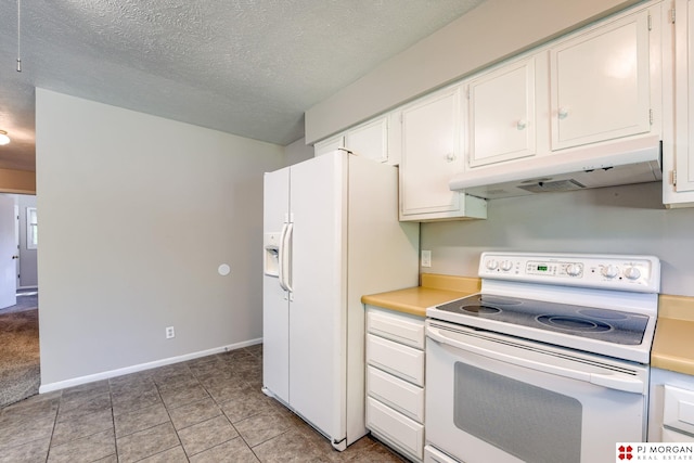 2811 S 36th St, Omaha, NE 68105 - kitchen with white appliances, under cabinet range hood, light countertops, a textured ceiling, and white cabinets