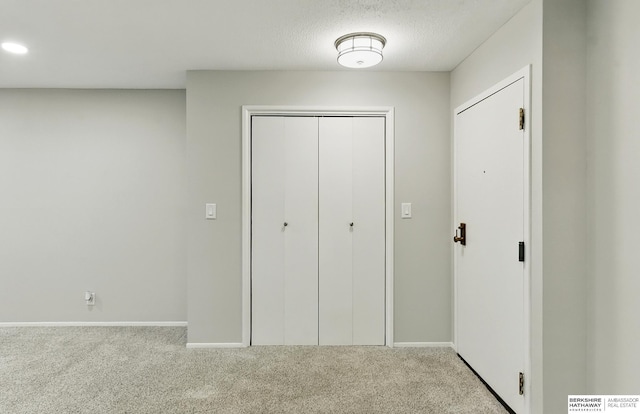 12727 W Dodge Rd Unit 124C, Omaha, NE 68154 - unfurnished bedroom featuring carpet flooring, a closet, a textured ceiling, and recessed lighting