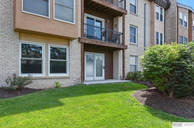 12727 W Dodge Rd Unit 124C, Omaha, NE 68154 - entrance to property featuring a balcony, stucco siding, a lawn, and brick siding