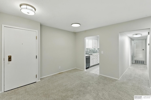 12727 W Dodge Rd Unit 124C, Omaha, NE 68154 - spare room with light colored carpet and a sink