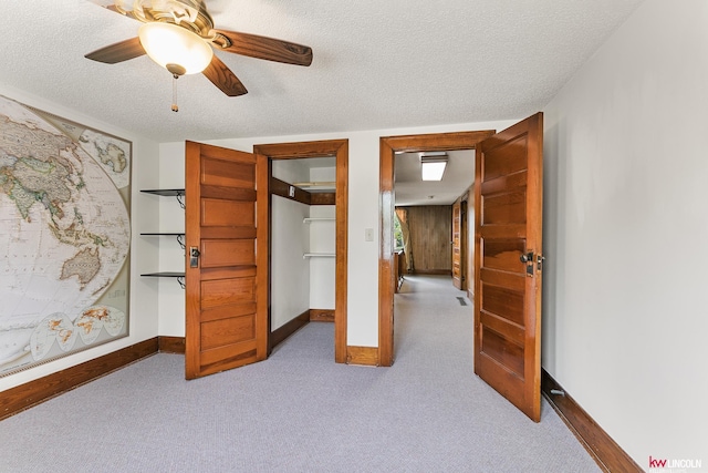 210 W Moravia Ave, Prague, NE 68050 - unfurnished bedroom with carpet, a textured ceiling, and ceiling fan