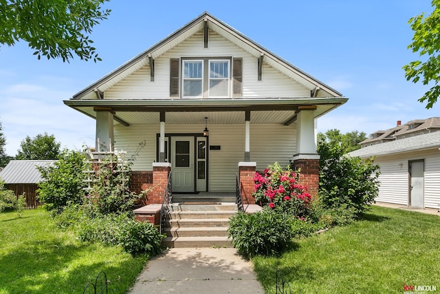 210 W Moravia Ave, Prague, NE 68050 - view of front of home featuring a porch and a front yard