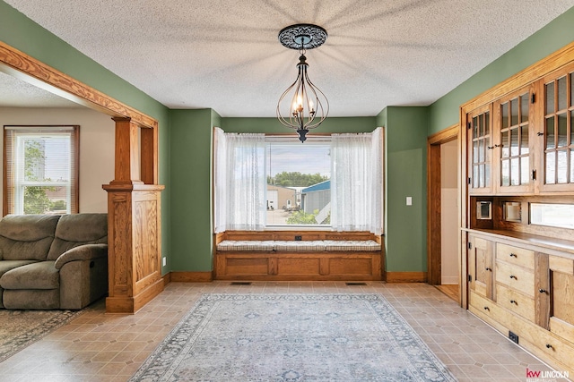 210 W Moravia Ave, Prague, NE 68050 - dining area featuring a textured ceiling, a chandelier, and light tile patterned flooring