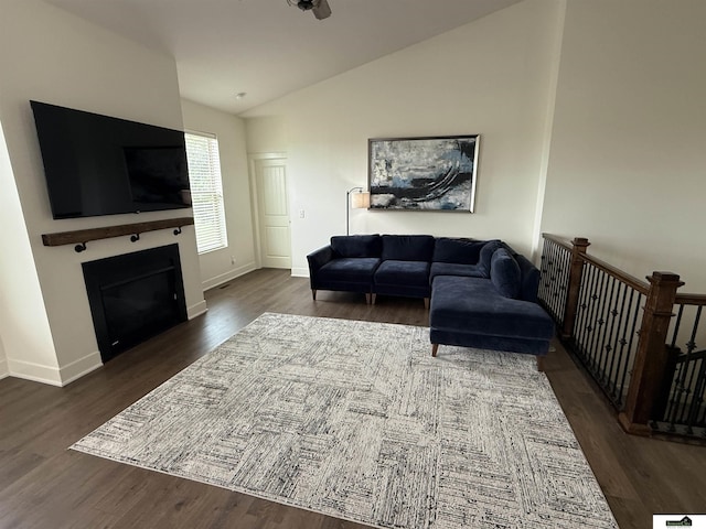 2308 Alexandra Rd, Papillion, NE 68133 - living room featuring vaulted ceiling, a glass covered fireplace, and dark wood-style floors
