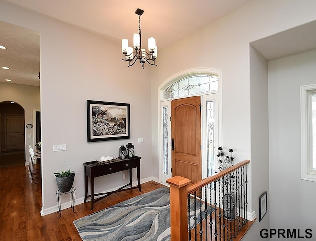 1526 Provencal Cir, Yutan, NE 68073 - foyer entrance with a chandelier, arched walkways, wood finished floors, plenty of natural light, and recessed lighting