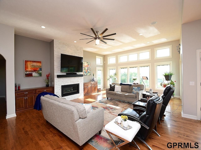 1526 Provencal Cir, Yutan, NE 68073 - living room featuring a stone fireplace, a ceiling fan, wood finished floors, and recessed lighting