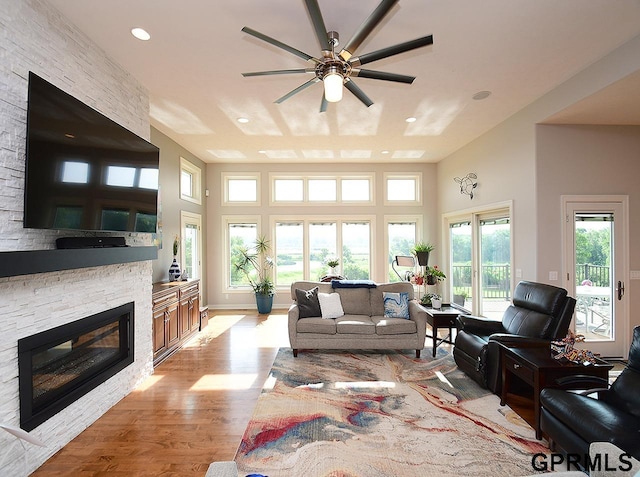 1526 Provencal Cir, Yutan, NE 68073 - living area with ceiling fan, a fireplace, light wood-style floors, recessed lighting, and a high ceiling