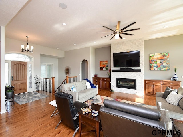 1526 Provencal Cir, Yutan, NE 68073 - living room featuring light wood-type flooring, a large fireplace, arched walkways, recessed lighting, and ceiling fan