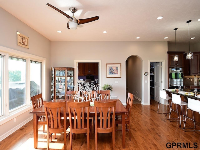 1526 Provencal Cir, Yutan, NE 68073 - dining area with arched walkways, a ceiling fan, light wood-style flooring, and recessed lighting