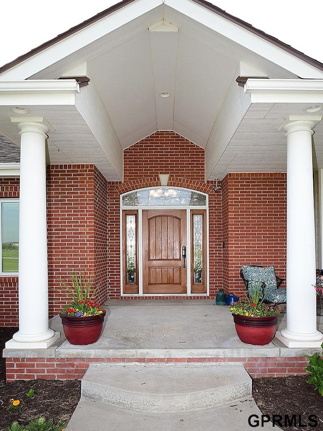1526 Provencal Cir, Yutan, NE 68073 - view of exterior entry with brick siding and a porch