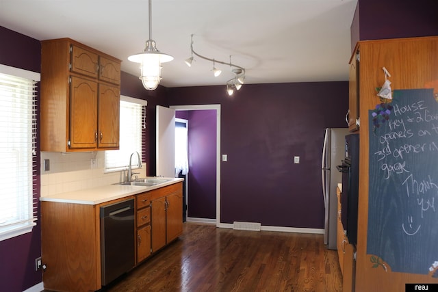 1912 Freeman Dr, Bellevue, NE 68005 - kitchen with dishwashing machine, light countertops, brown cabinetry, and dark wood-type flooring