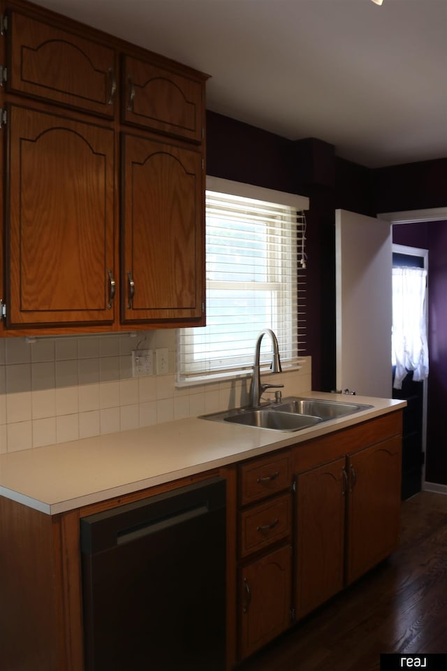 1912 Freeman Dr, Bellevue, NE 68005 - kitchen with dishwasher, dark wood-style flooring, decorative backsplash, and plenty of natural light