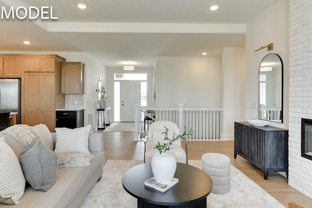 12386 Fenwick St, Papillion, NE 68046 - living area featuring light wood-style floors, a fireplace, and recessed lighting