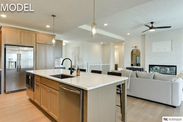12386 Fenwick St, Papillion, NE 68046 - kitchen with appliances with stainless steel finishes, light wood-type flooring, ceiling fan, a kitchen bar, and recessed lighting