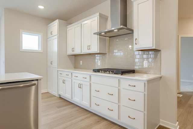 12382 Fenwick St, Papillion, NE 68046 - kitchen featuring wall chimney exhaust hood, appliances with stainless steel finishes, light wood-type flooring, decorative backsplash, and light countertops