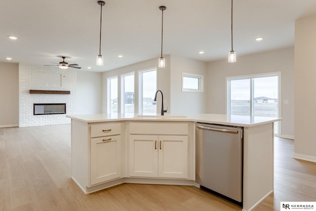 12382 Fenwick St, Papillion, NE 68046 - kitchen featuring dishwasher, light wood-style flooring, plenty of natural light, light countertops, and recessed lighting
