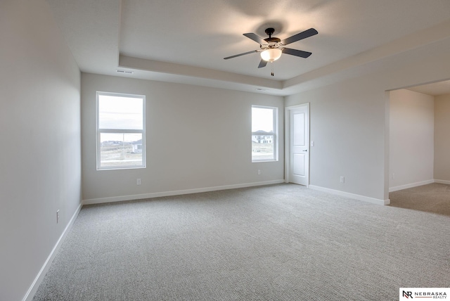 12382 Fenwick St, Papillion, NE 68046 - spare room featuring ceiling fan, light carpet, and a raised ceiling