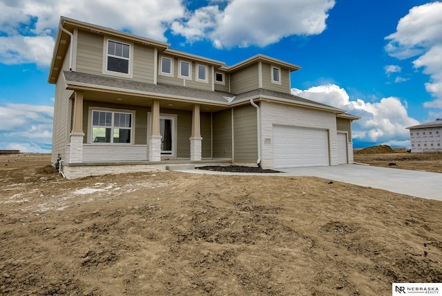 12382 Fenwick St, Papillion, NE 68046 - view of front of home featuring covered porch, concrete driveway, an attached garage, and roof with shingles
