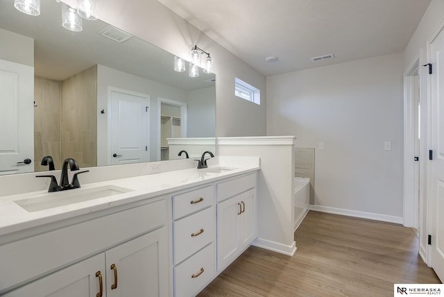 12382 Fenwick St, Papillion, NE 68046 - full bath with a bath, double vanity, and wood finished floors