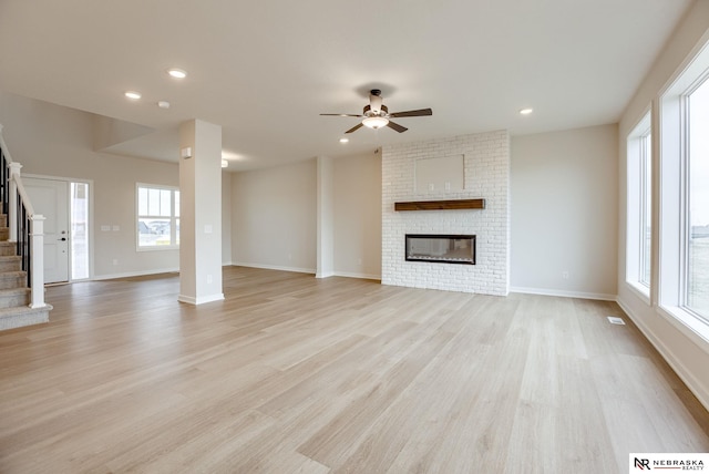 12382 Fenwick St, Papillion, NE 68046 - unfurnished living room with stairway, a ceiling fan, light wood-style flooring, a fireplace, and recessed lighting
