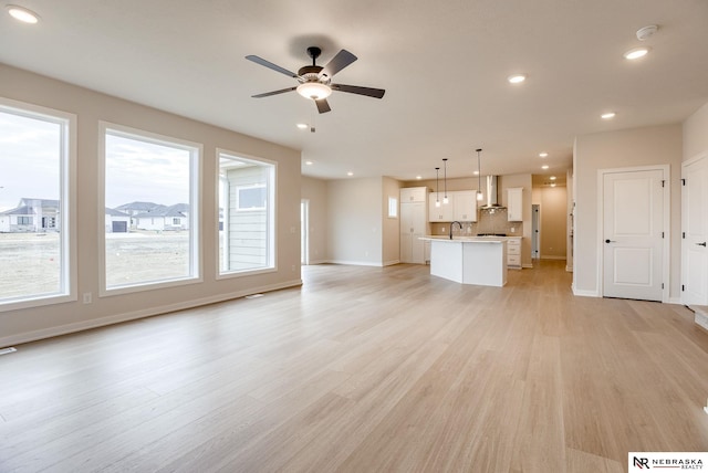 12382 Fenwick St, Papillion, NE 68046 - unfurnished living room with a ceiling fan, light wood-style flooring, and recessed lighting