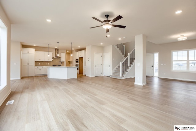 12382 Fenwick St, Papillion, NE 68046 - unfurnished living room featuring ceiling fan, light wood finished floors, stairway, and recessed lighting